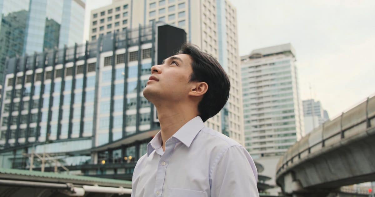 Jeune homme en chemise observent gratte ciel de Bangkok